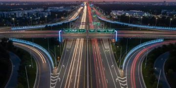 Modern highway infrastructure with advanced safety features and clear signage at dusk, representing DOT's 2026 investment.